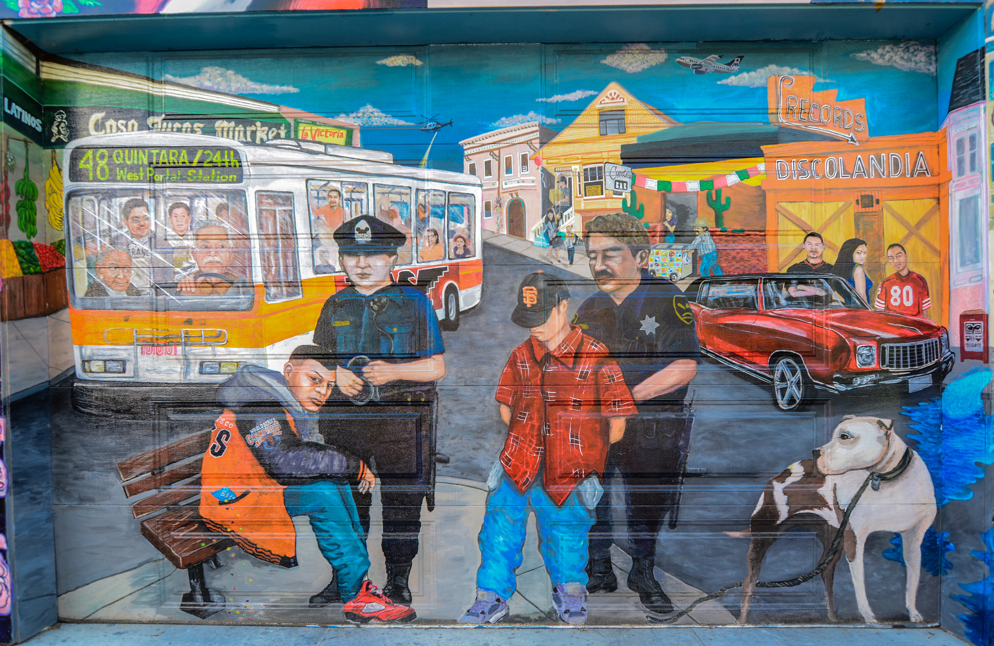 street art of two cops arresting youth immigrants in the Mission district