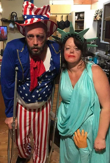 two costumes of "currently abused government": uncle sam all beat up, and a groped statue of liberty